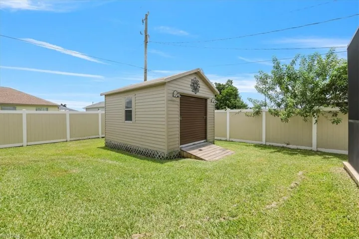 View of shed with a fenced backyard
