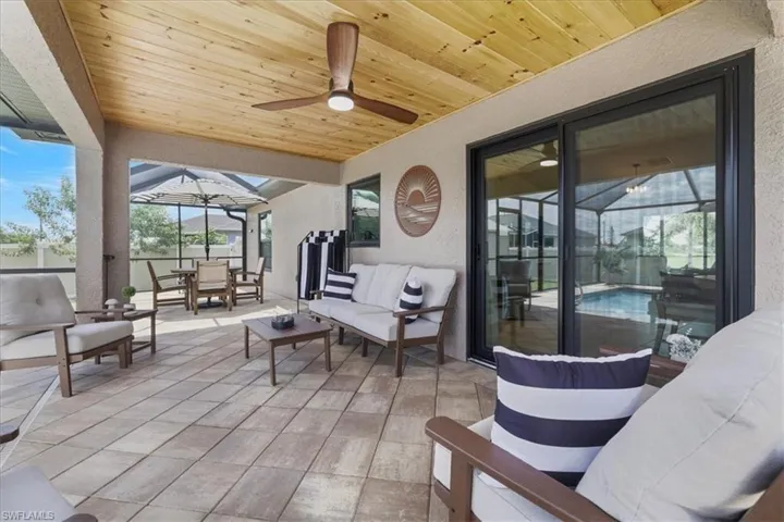 View of patio with outdoor dining space, a ceiling fan, and an outdoor hangout area