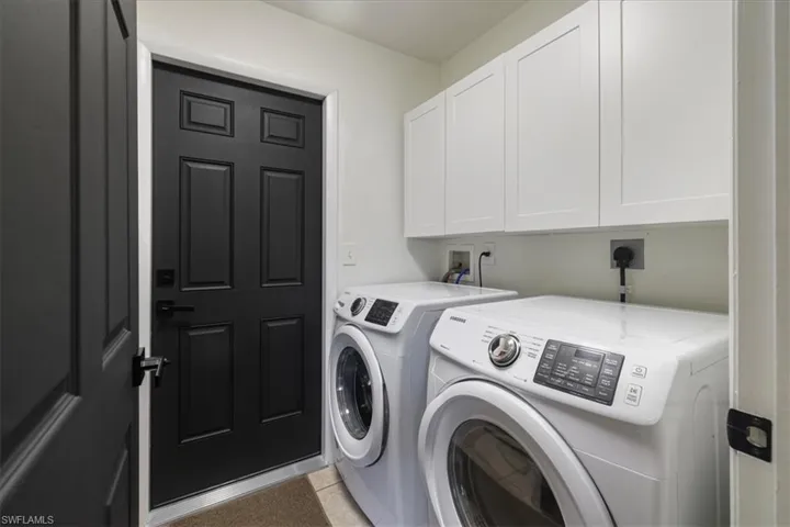 Laundry area with washing machine and clothes dryer and cabinet space