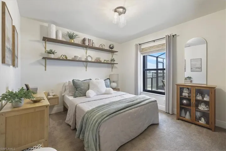 Bedroom featuring carpet flooring and baseboards