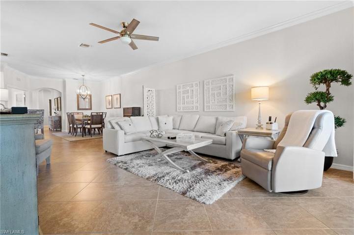 Great room with large tile on the diagonal and new furniture