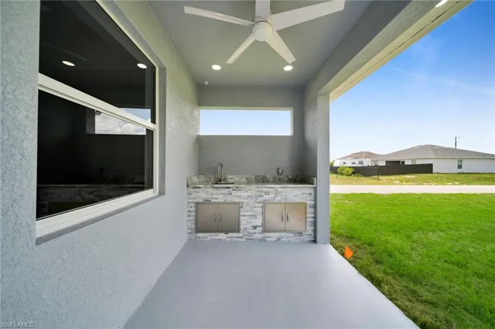 View of patio featuring exterior kitchen and ceiling fan