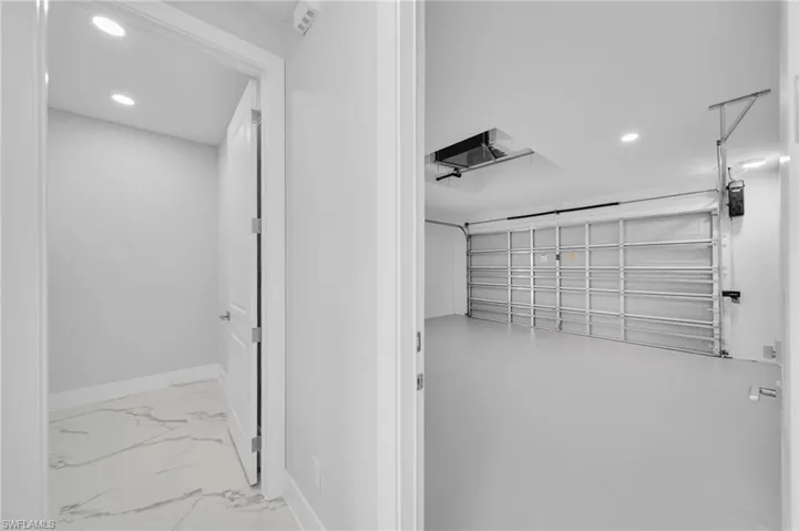 Garage featuring recessed lighting and baseboards