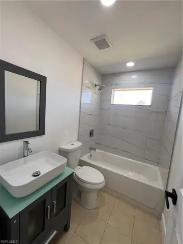 Full bathroom featuring vanity, bathing tub / shower combination, and light tile patterned floors