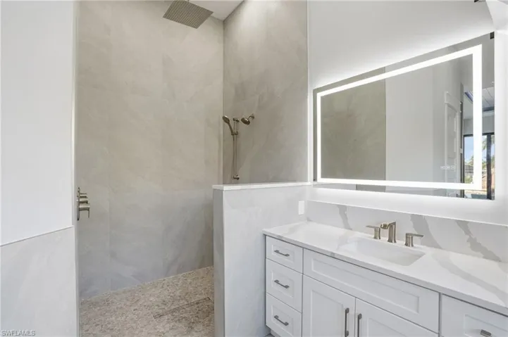 Full bathroom with vanity and walk in shower