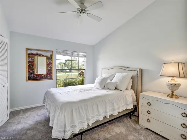 Bedroom featuring lofted ceiling, carpet, ceiling fan, and a closet