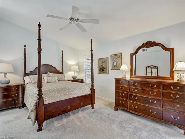 Bedroom featuring light colored carpet and ceiling fan