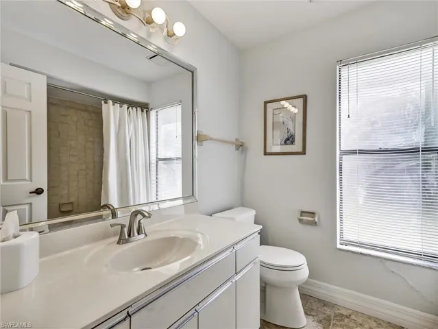 Full bath with vanity and a shower with curtain
