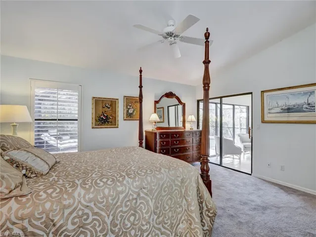 Bedroom with access to exterior, carpet, a ceiling fan, and vaulted ceiling