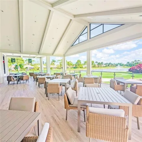 Outdoor dining area, view of golf course, and a water view