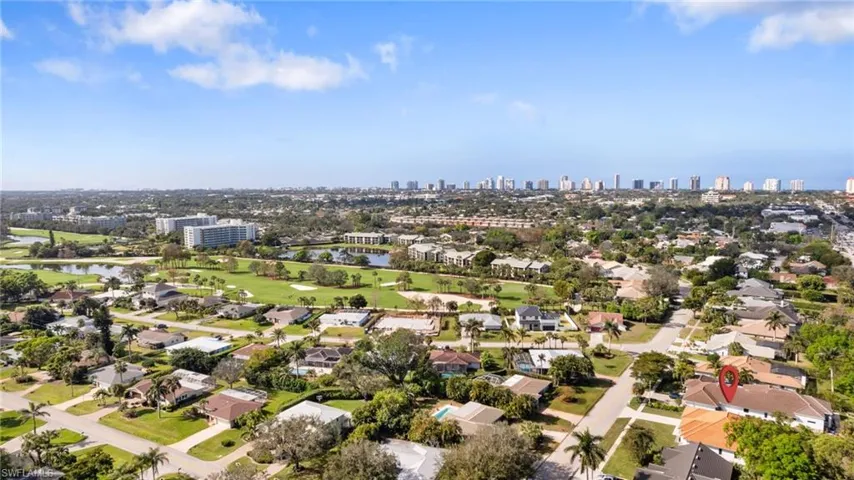 Aerial overview of property's location with a large body of water and city skyline