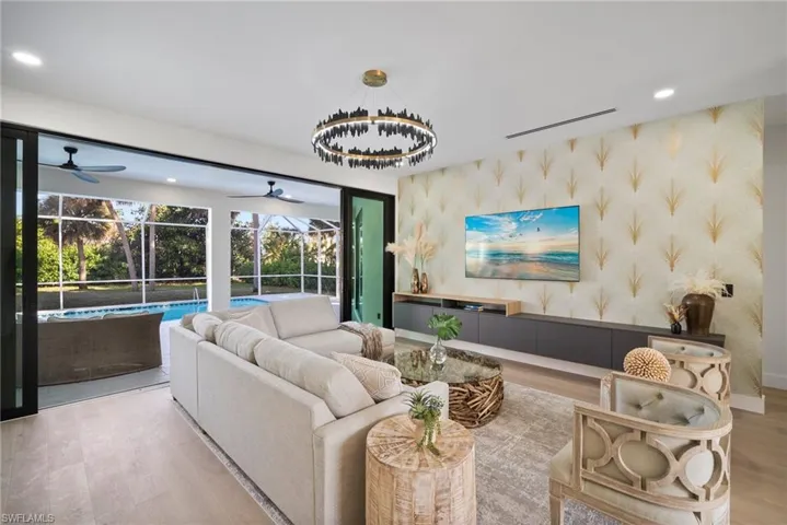 Living area featuring recessed lighting, wallpapered walls, wood finished floors, a sunroom, and a ceiling fan