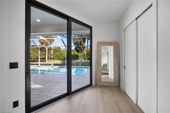 Entryway featuring a sunroom and wood finished floors