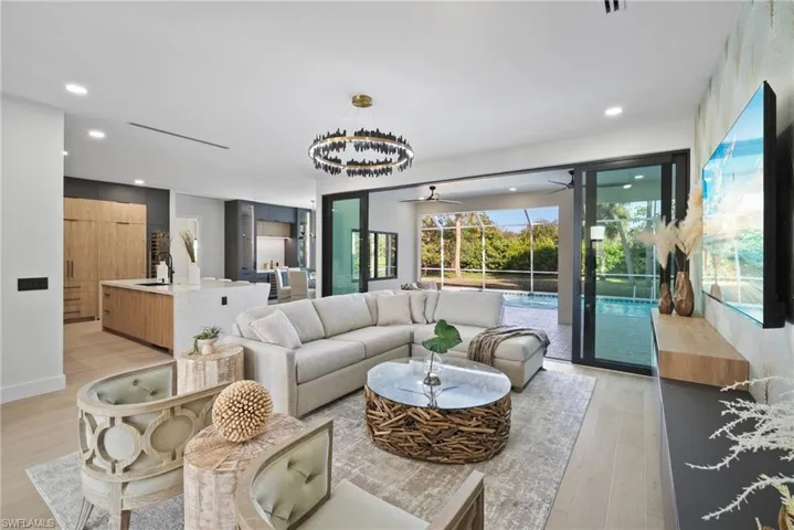 Living room featuring ceiling fan, light wood finished floors, and recessed lighting