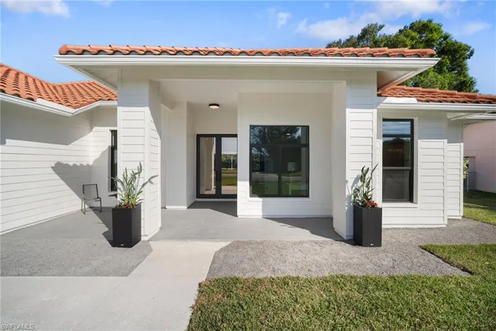 Doorway to property featuring a tile roof