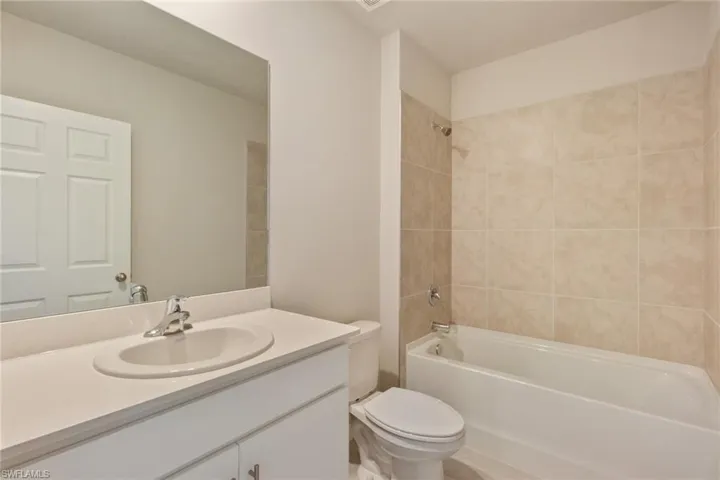 Bathroom featuring washtub / shower combination and vanity