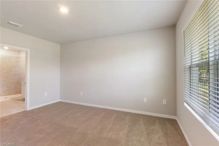 Unfurnished room featuring light colored carpet and recessed lighting