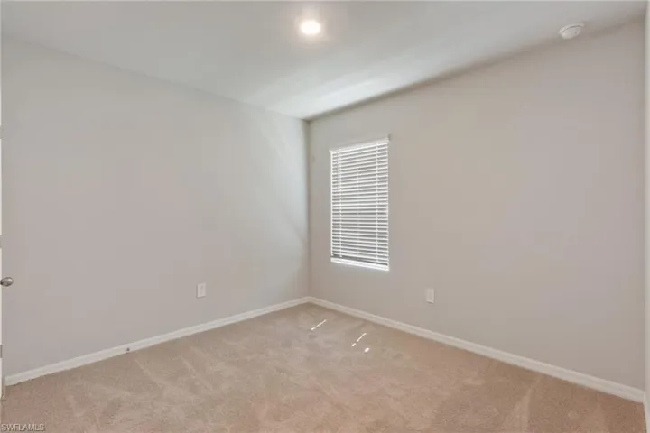 Unfurnished room with baseboards and carpet flooring