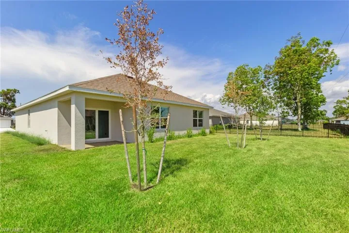 Back of property with stucco siding and a patio area