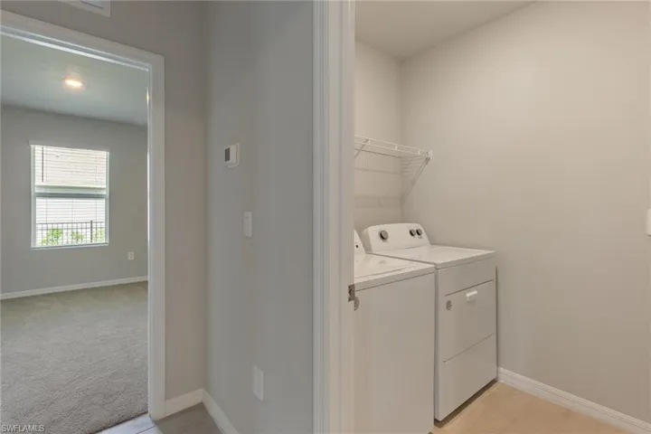Laundry area featuring washing machine and dryer, recessed lighting, and light colored carpet