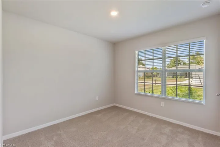 Empty room featuring light colored carpet and recessed lighting