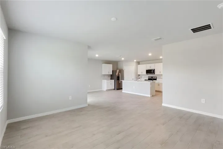 Unfurnished living room with recessed lighting and light wood finished floors