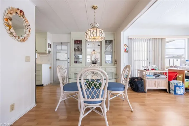 Dining room with light wood-style flooring and healthy amount of natural light