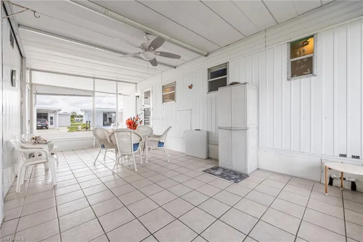 Sunroom with ceiling fan and outdoor dining area
