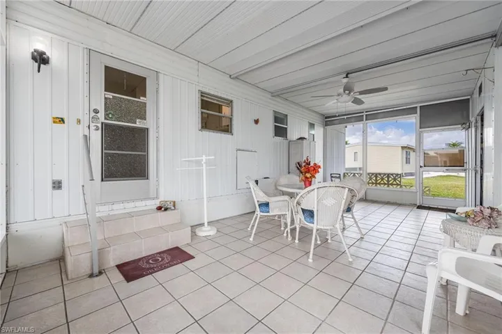 Sunroom with a ceiling fan and outdoor dining space