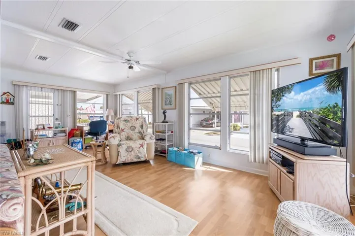 Living room with light wood-style flooring and ceiling fan