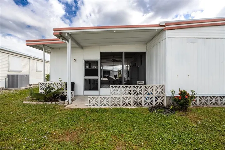 Back of property with a yard and a patio