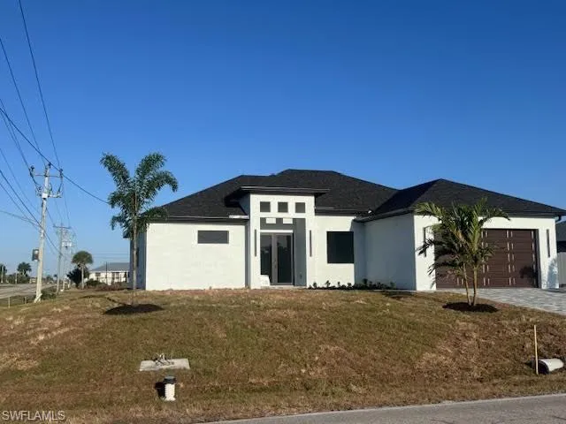 Contemporary stucco exterior with a dark shingle roof