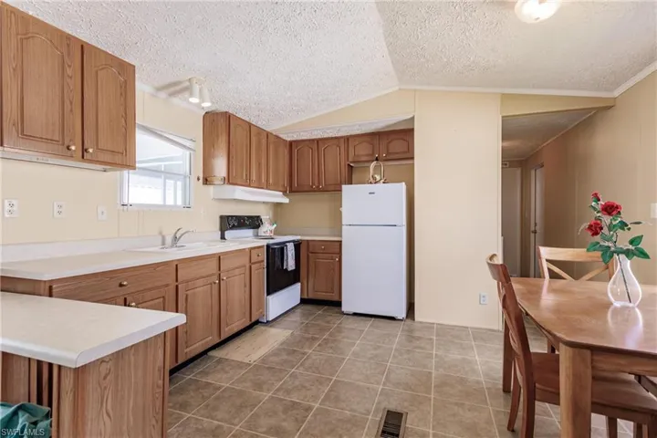 Kitchen with breakfast bar and dining area
