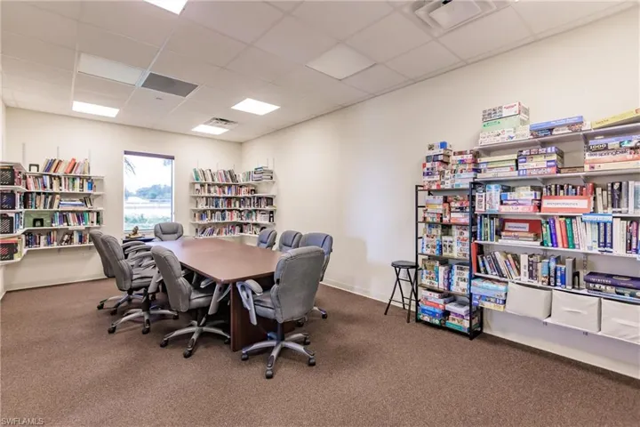 Community Library with carpet flooring and a paneled ceiling