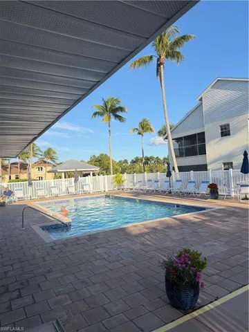 Community pool with a patio