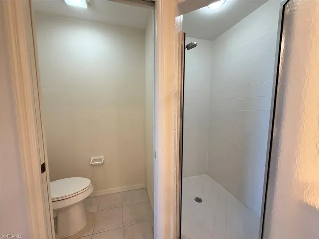 Full bathroom with a stall shower and light tile patterned floors