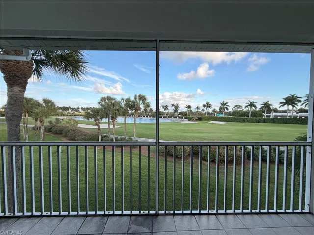 Unfurnished sunroom featuring a water view and golf course view