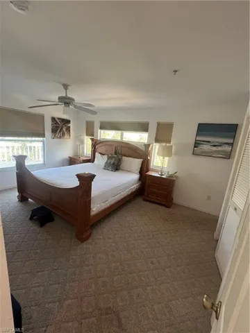 Bedroom featuring carpet, a closet, ceiling fan, and multiple windows