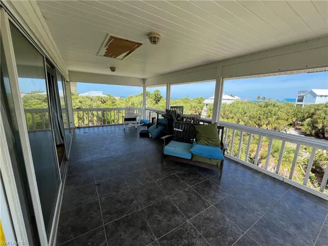 View of patio with a balcony