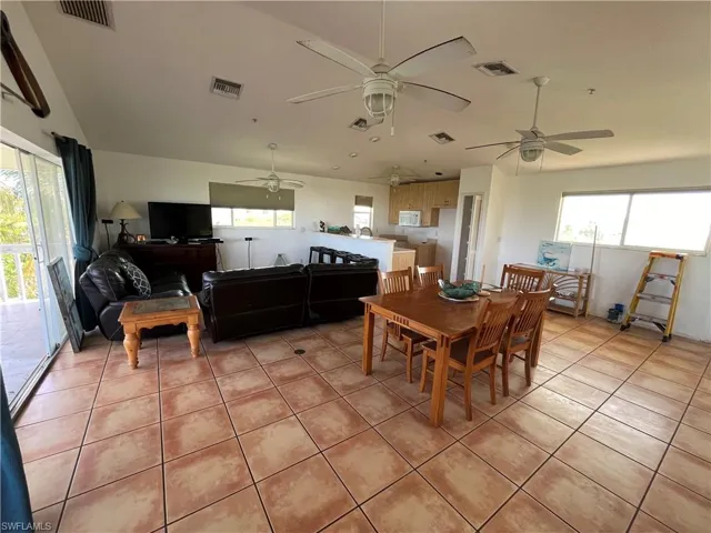 Dining room with ceiling fan and light tile floors