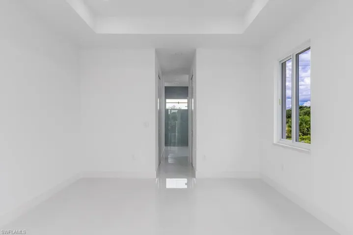 Unfurnished room with a raised ceiling and tile flooring