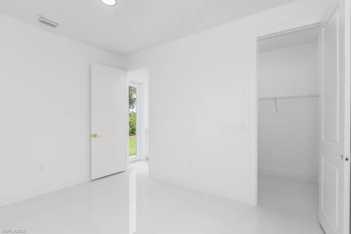 Unfurnished bedroom featuring tile flooring and a closet