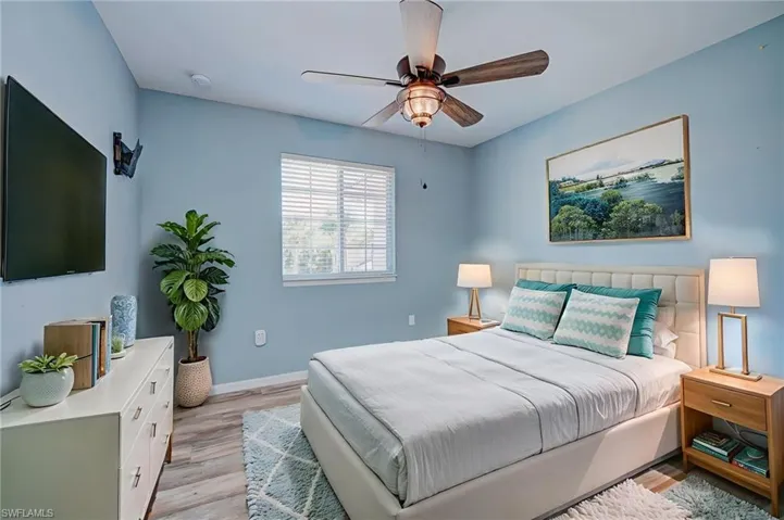 Bedroom with light wood finished floors and ceiling fan