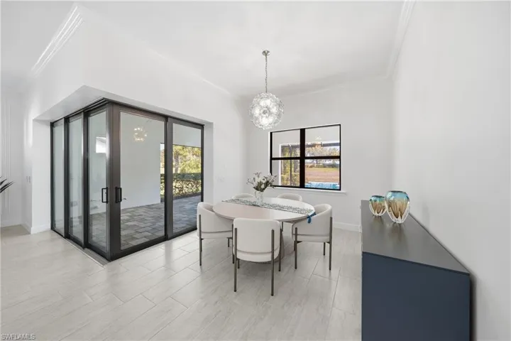 Open dining area seamlessly connected to the kitchen and living space, enhanced by fresh paint and updated lighting for a bright, cohesive feel.