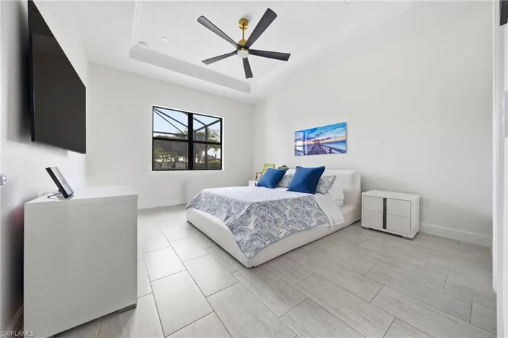 Primary bedroom with new ceiling fan and fresh neutral paint