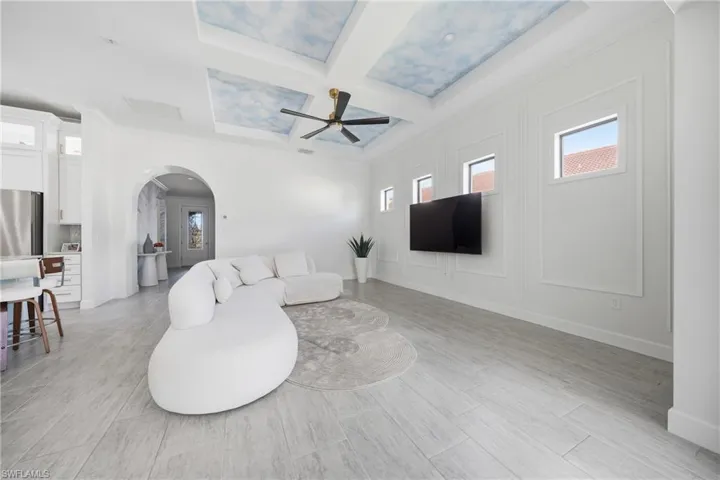 Bright great room with new ceiling fan and freshly painted walls