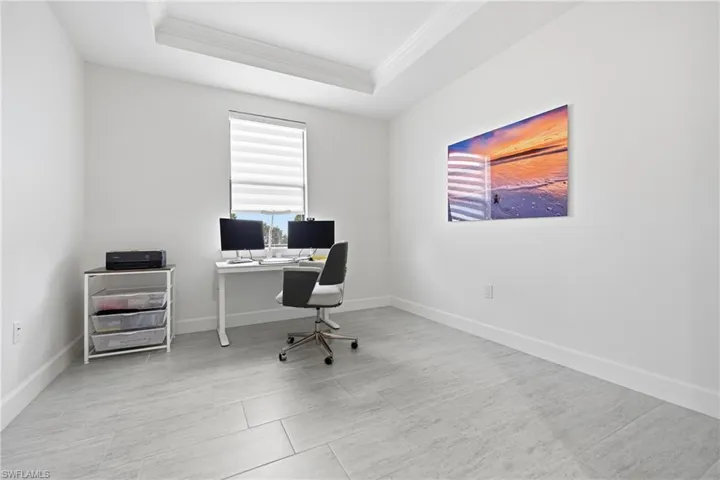 Private office or den featuring fresh interior paint, new lighting, and a modern ceiling fan. Bright, flexible space ideal for a home office, study, or guest room, with clean finishes and a quiet location within the home.