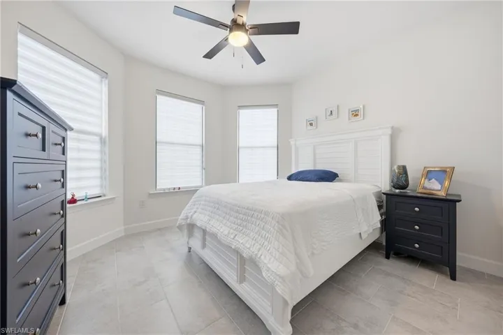 Guest bedroom with new tile flooring and updated lighting