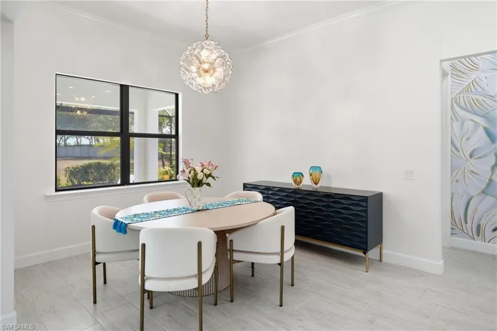 Inviting dining area designed for gathering, featuring updated lighting, fresh paint, and an open connection to the kitchen and main living space.