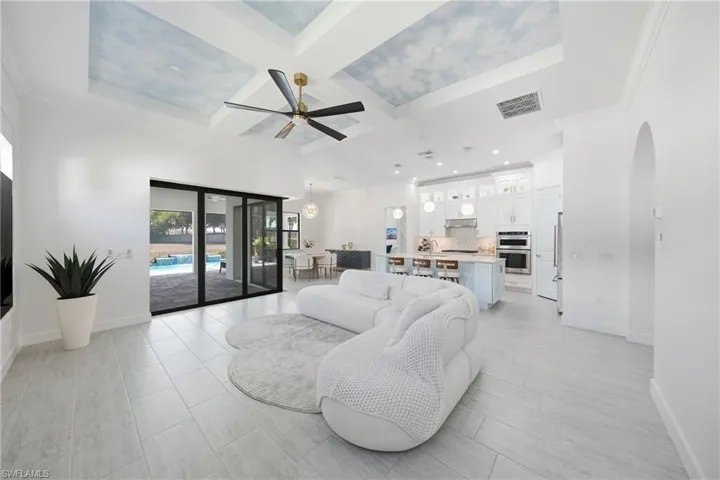 Living room featuring custom painted and textured ceiling for added depth